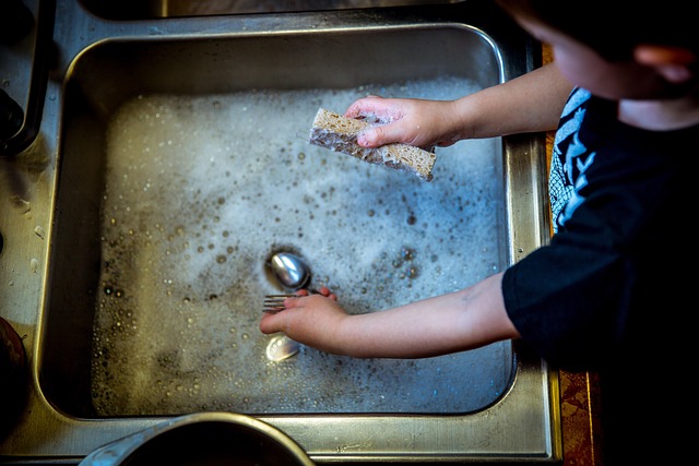 シンクで食器を洗う子ども