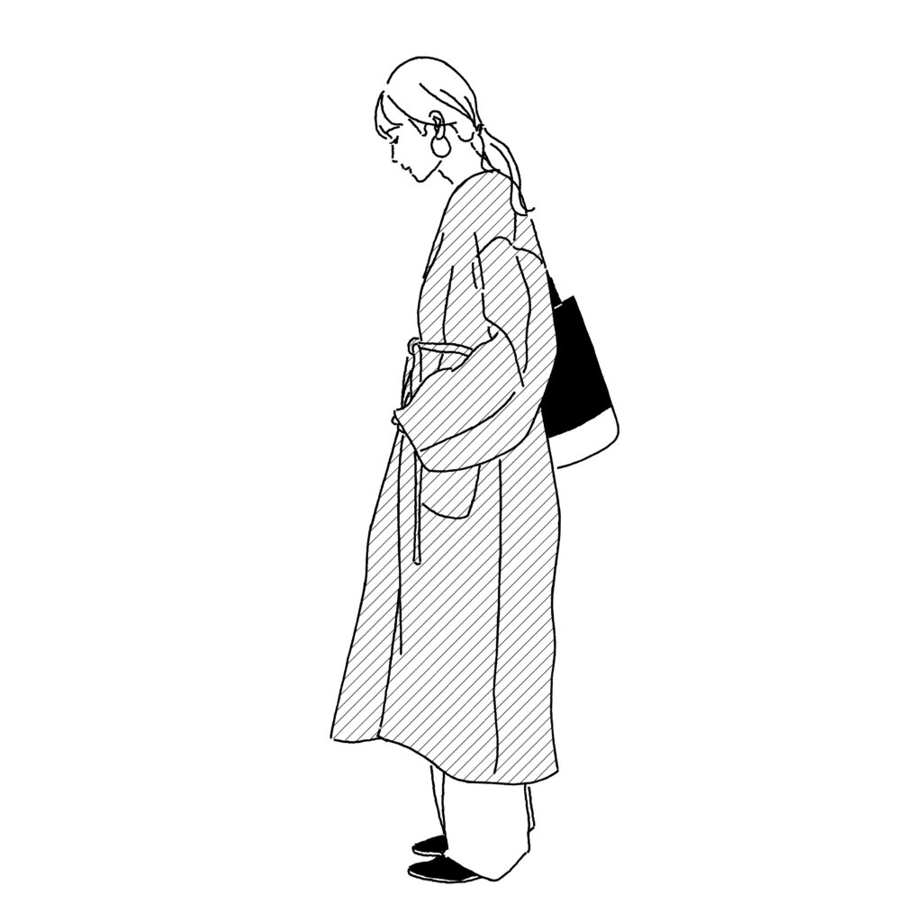 ロングコートを着た女性　横向き