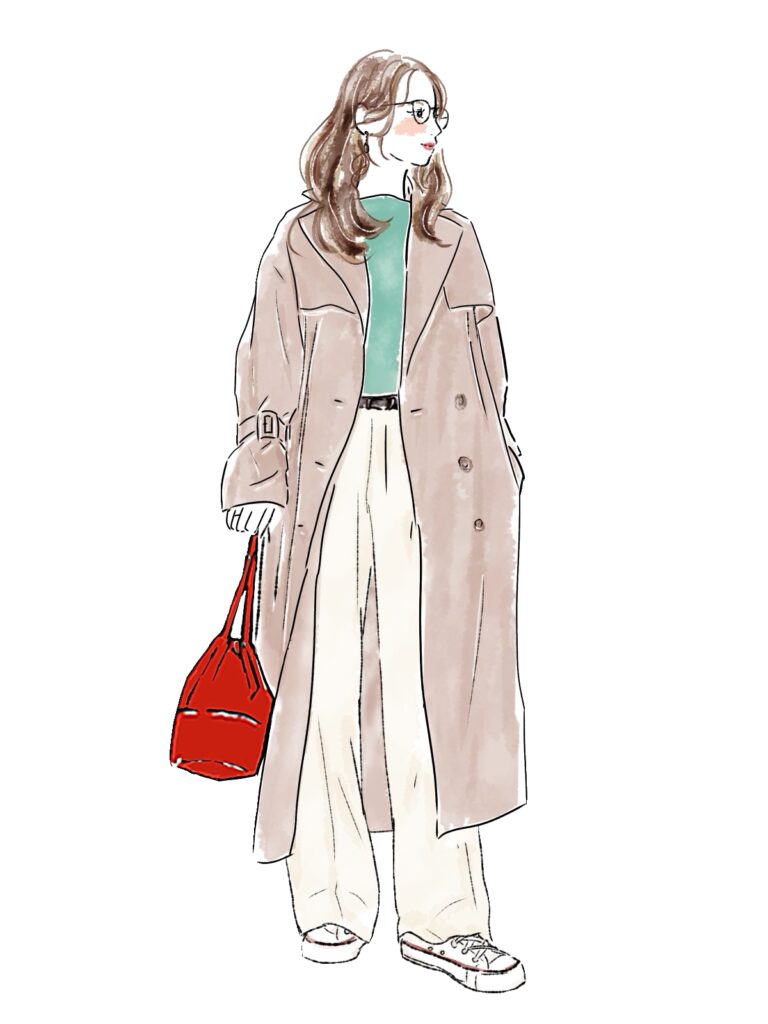 ロングコートを着た女性　白いパンツスタイル