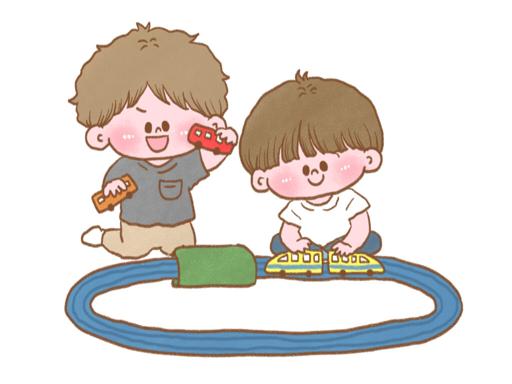 電車のおもちゃで遊ぶ男の子たち