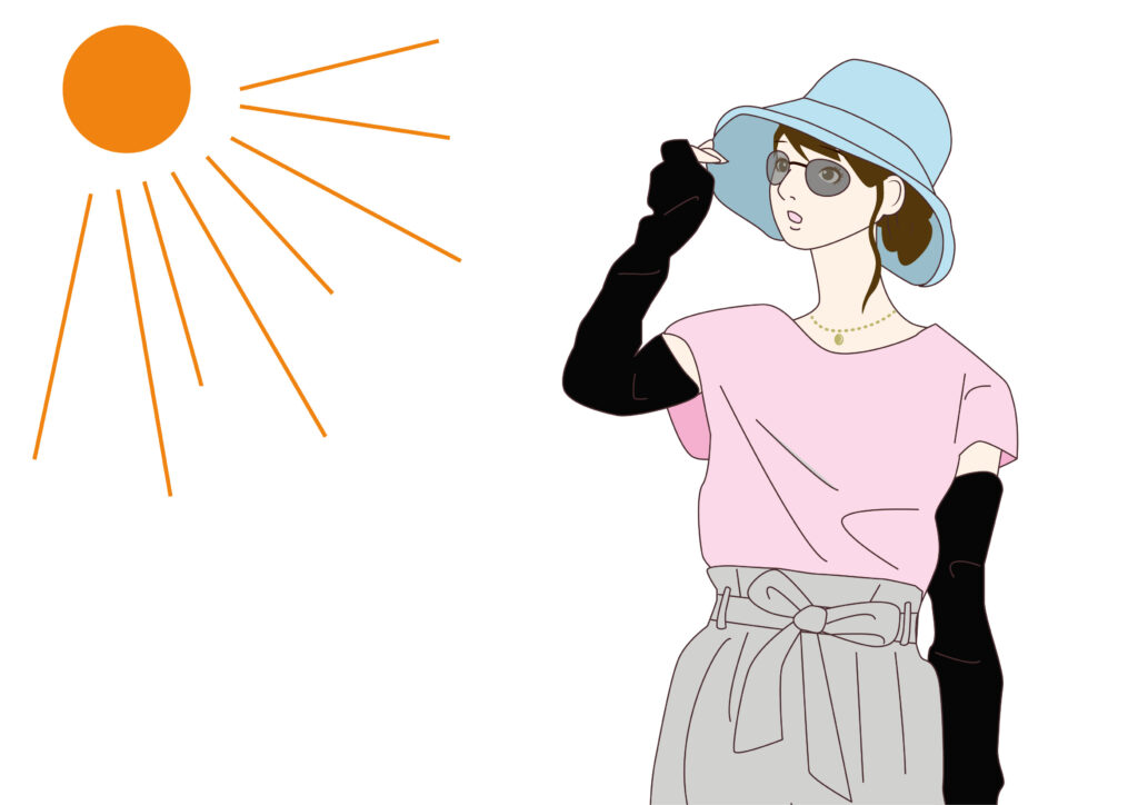 太陽と冷感タイプのアームカバーを付ける女性